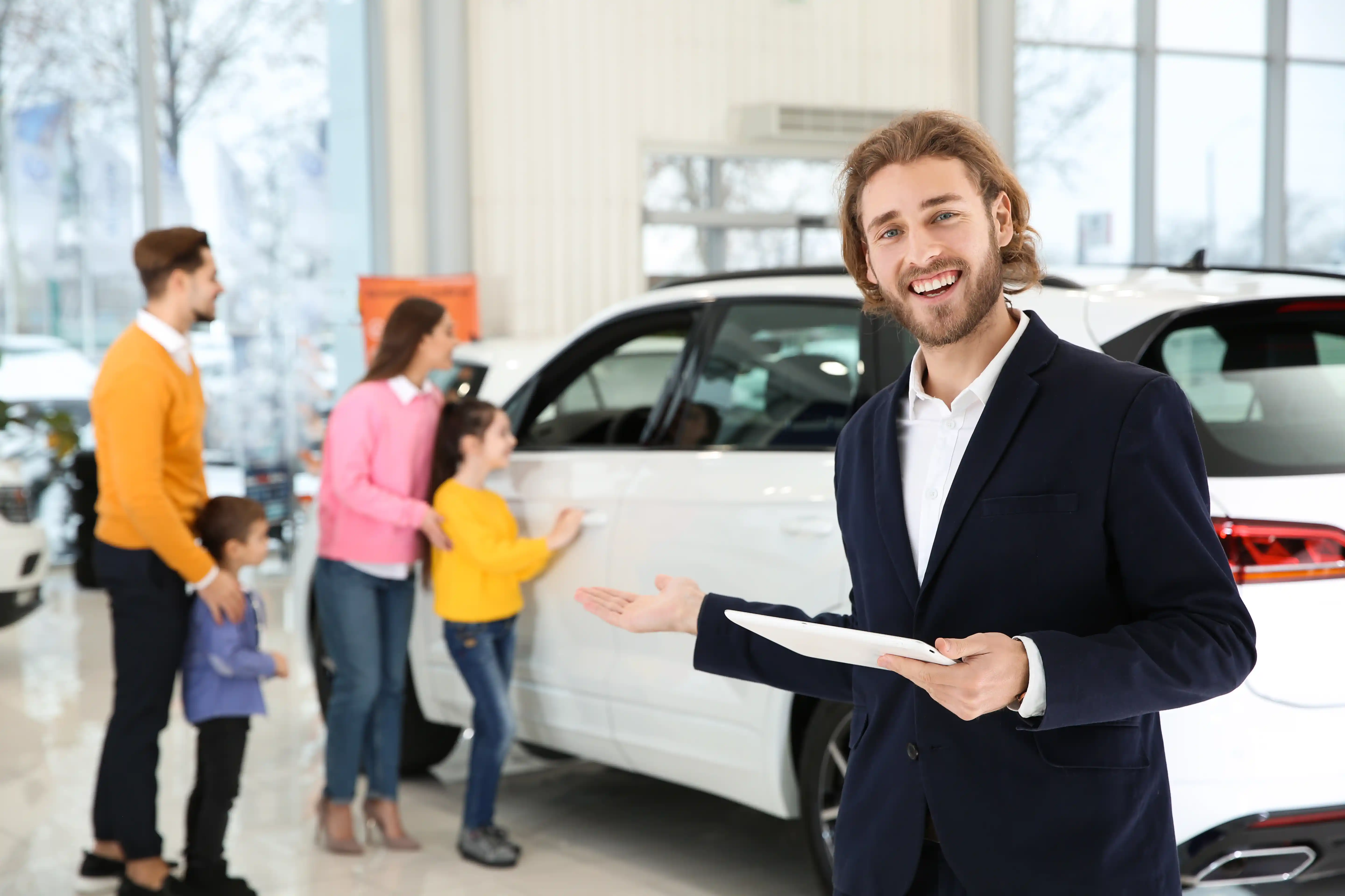 Family reviewing a vehicle with a dealership representative